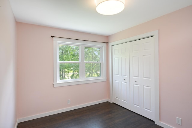 24182 184th St NW, Orrock Twp, MN 55309 - unfurnished bedroom with baseboards, dark wood-style floors, and a closet