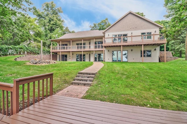 back of property featuring a lawn and a wooden deck