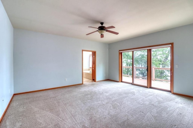 empty room with carpet floors, baseboards, and a ceiling fan