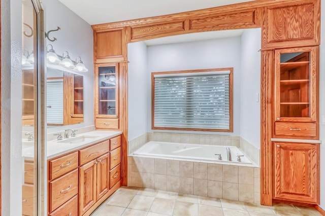 bathroom with vanity, tile patterned floors, and a bath