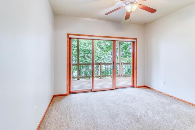 empty room featuring baseboards, ceiling fan, and carpet