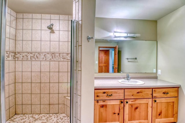 bathroom featuring a shower stall and vanity