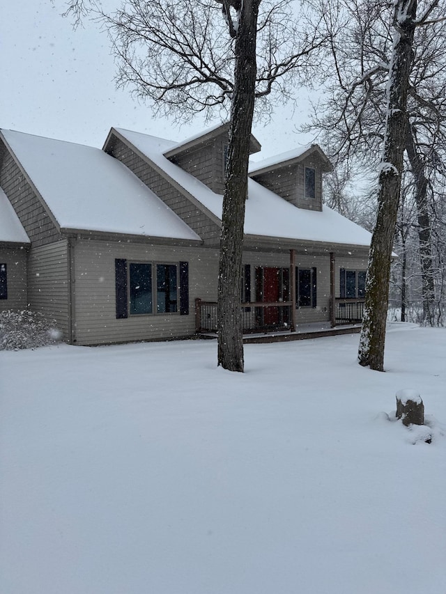 snow covered house with brick siding