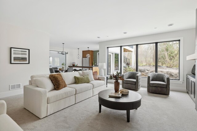 1774 Dodd Rd, Mendota Heights, MN 55118 - living area with visible vents, light colored carpet, and baseboards