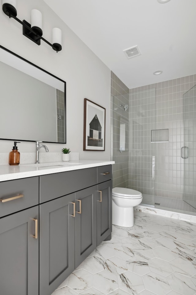 1774 Dodd Rd, Mendota Heights, MN 55118 - full bath with vanity, toilet, a shower stall, visible vents, and marble finish floor