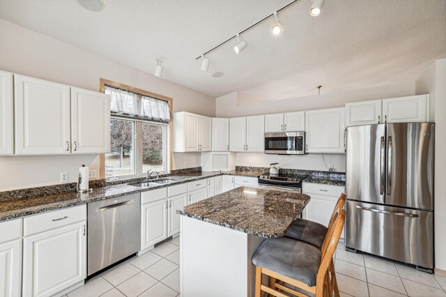 kitchen featuring a sink, white cabinets, and stainless steel appliances