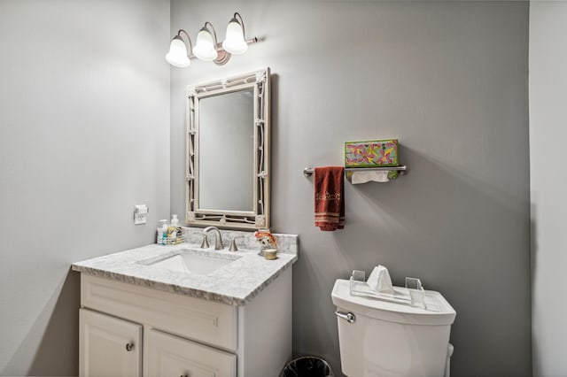 half bathroom with vanity and toilet