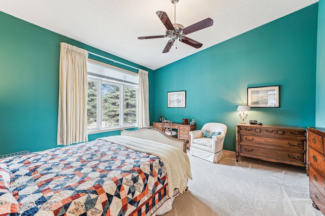carpeted bedroom with a textured ceiling, ceiling fan, and lofted ceiling
