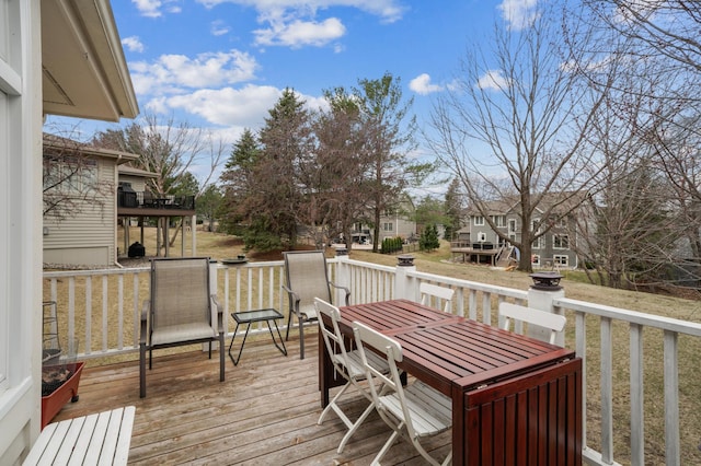wooden deck featuring a residential view and outdoor dining area