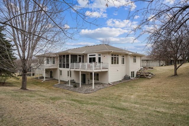 back of property with a patio area, central AC, a yard, a sunroom, and a shingled roof