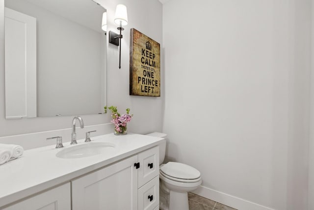 half bathroom with tile patterned flooring, toilet, vanity, and baseboards