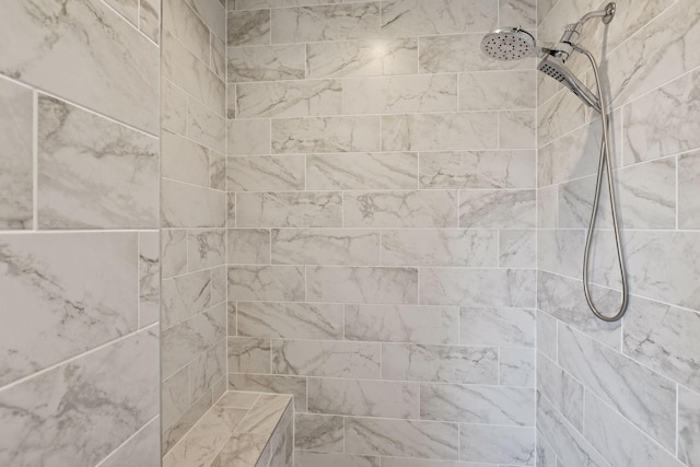 interior details featuring tiled shower