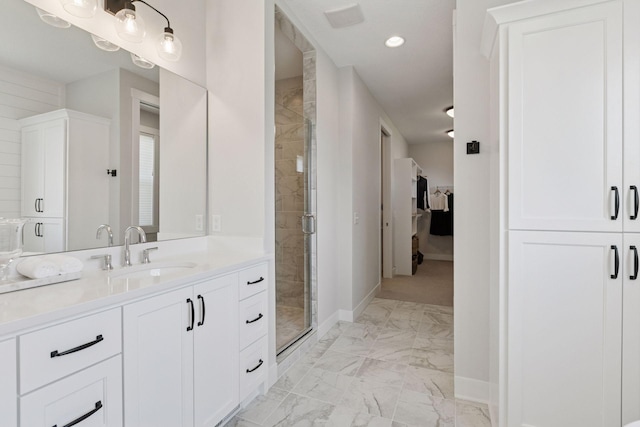 full bath with baseboards, vanity, marble finish floor, and a shower stall