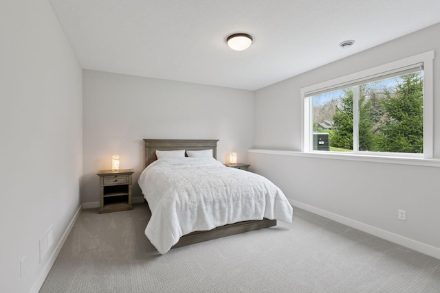 bedroom with baseboards and carpet