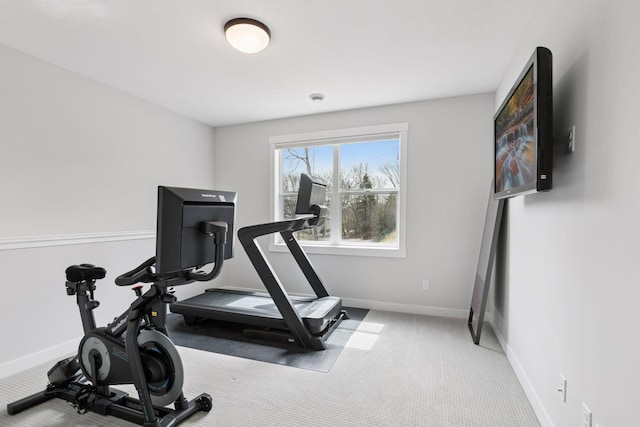 workout room with baseboards and carpet flooring
