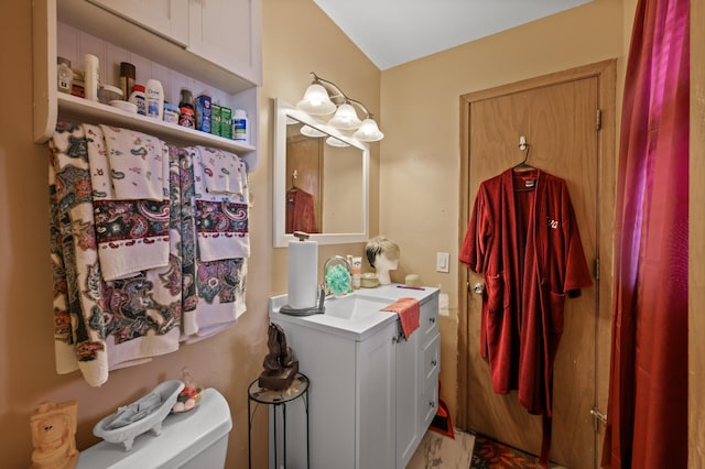bathroom featuring toilet and vanity