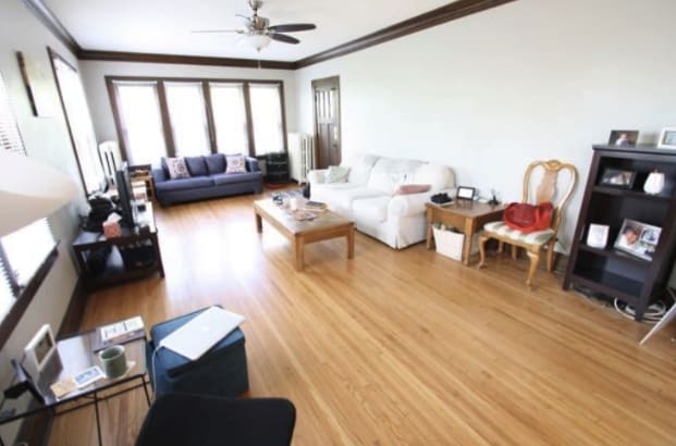 living room featuring ceiling fan, light wood-type flooring, and crown molding