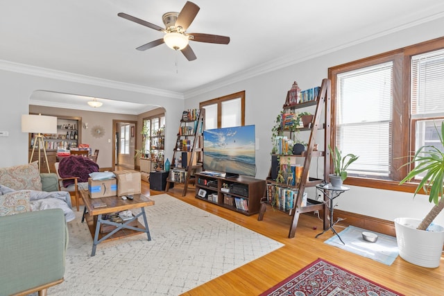 382 Fry St, Saint Paul, MN 55104 - living area with wood finished floors, crown molding, arched walkways, a ceiling fan, and baseboards