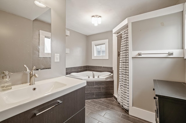 bathroom with wood tiled floor, curtained shower, vanity, and a garden tub