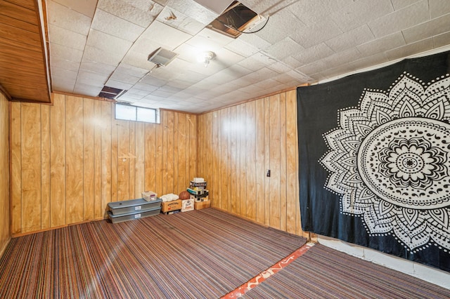 interior space featuring wood walls and carpet flooring