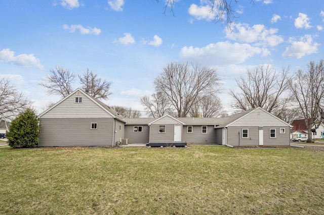 rear view of property featuring a yard and a wooden deck