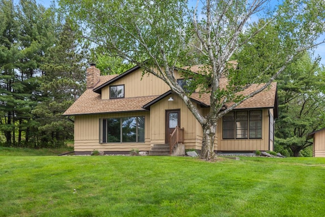 2591 Carver Ave E, Maplewood, MN 55119 - view of front facade featuring a chimney, roof with shingles, and a front lawn