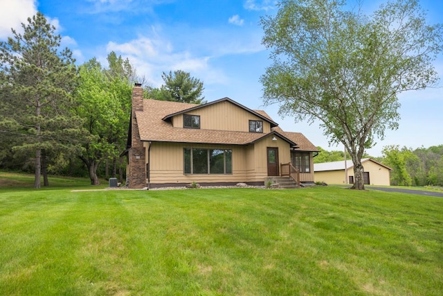 2591 Carver Ave E, Maplewood, MN 55119 - view of front of property with a chimney, a front yard, and a shingled roof