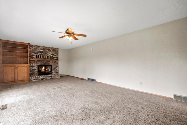 2591 Carver Ave E, Maplewood, MN 55119 - unfurnished living room featuring ceiling fan, carpet flooring, a fireplace, and baseboards