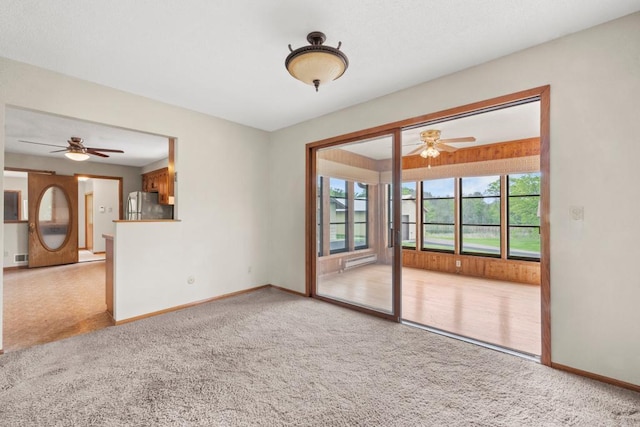 2591 Carver Ave E, Maplewood, MN 55119 - empty room featuring a ceiling fan, light colored carpet, and baseboards