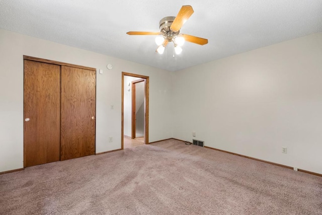 2591 Carver Ave E, Maplewood, MN 55119 - unfurnished bedroom with light carpet, a closet, baseboards, and a ceiling fan