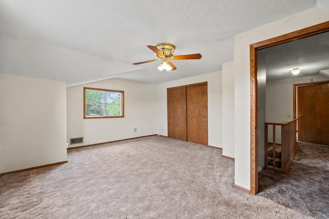 2591 Carver Ave E, Maplewood, MN 55119 - unfurnished bedroom featuring a textured ceiling, carpet flooring, a closet, baseboards, and ceiling fan