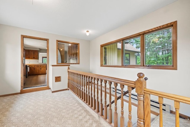 2591 Carver Ave E, Maplewood, MN 55119 - hallway featuring baseboards, an upstairs landing, and light carpet