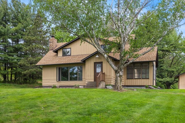 2591 Carver Ave E, Maplewood, MN 55119 - view of front of house featuring a chimney, roof with shingles, and a front yard