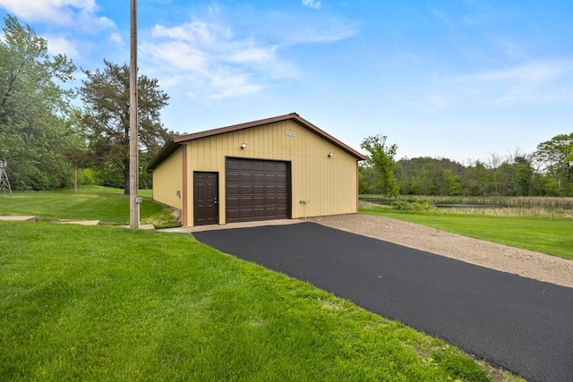 2591 Carver Ave E, Maplewood, MN 55119 - detached garage with asphalt driveway and a water view