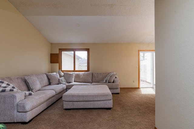 living room with carpet floors, lofted ceiling, and plenty of natural light