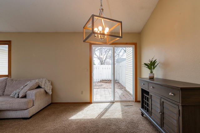 interior space featuring vaulted ceiling, baseboards, carpet, and a chandelier