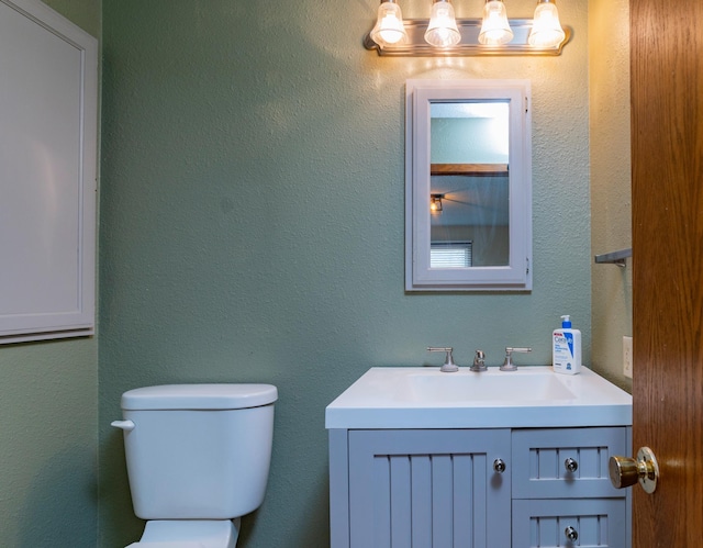 half bath with vanity and toilet