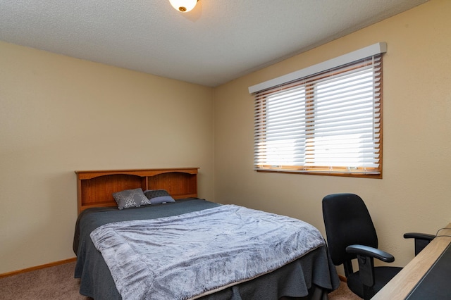 bedroom featuring baseboards and carpet