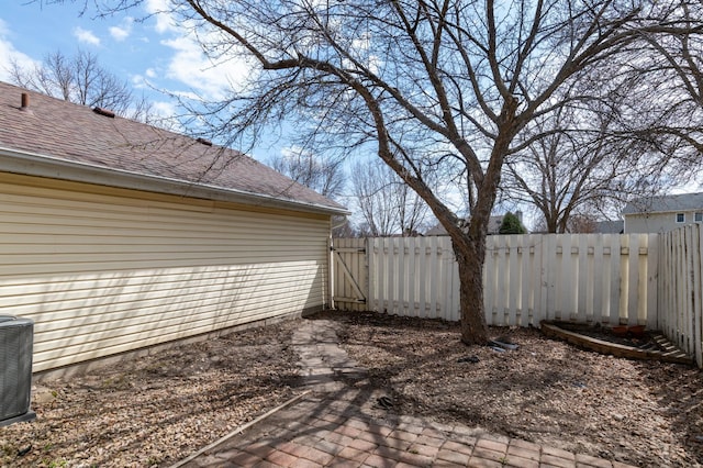 view of patio featuring fence, a gate, and central AC unit