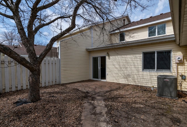 back of property with fence, central AC, and a patio