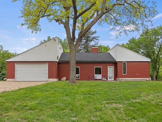 2595 Carver Ave E, Maplewood, MN 55119 - rear view of house featuring driveway, a garage, a lawn, a chimney, and roof with shingles