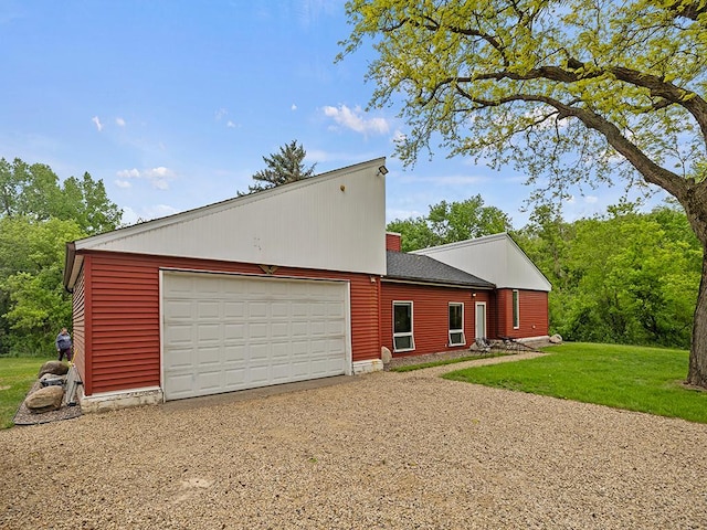 2595 Carver Ave E, Maplewood, MN 55119 - view of property exterior with driveway, an attached garage, a yard, and a chimney