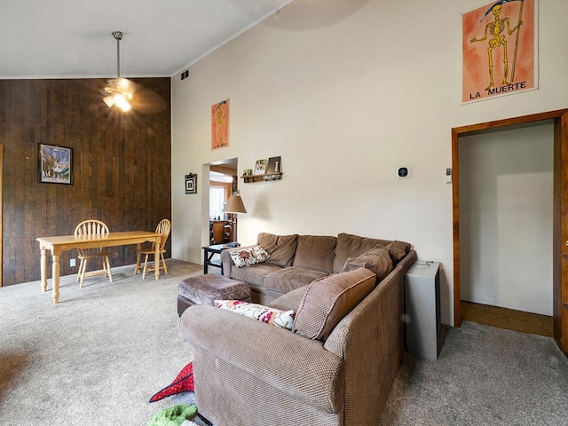 2595 Carver Ave E, Maplewood, MN 55119 - carpeted living area featuring a towering ceiling, a ceiling fan, wood walls, and crown molding