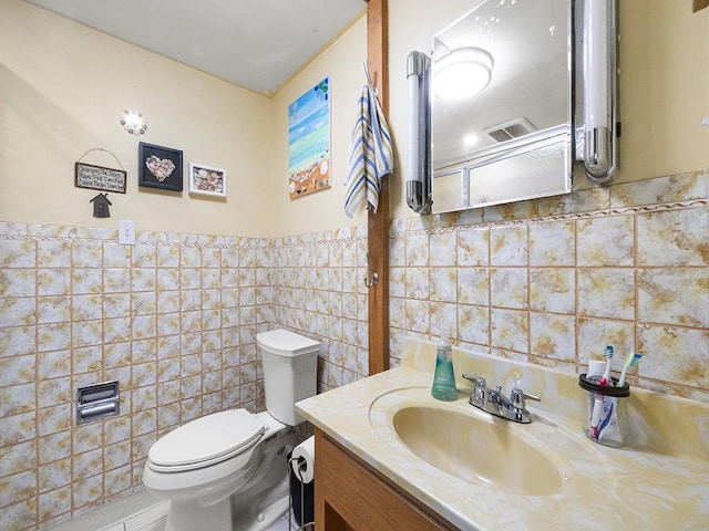2595 Carver Ave E, Maplewood, MN 55119 - half bath with tile walls, vanity, and toilet