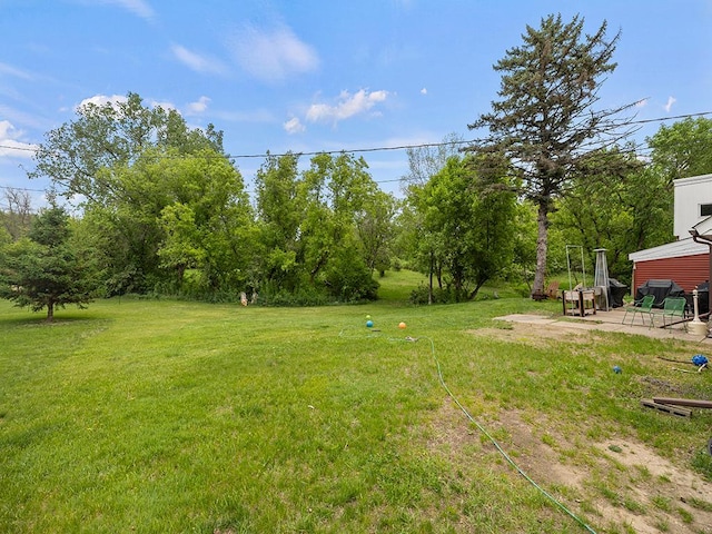2595 Carver Ave E, Maplewood, MN 55119 - view of green lawn with a patio and view of scattered trees