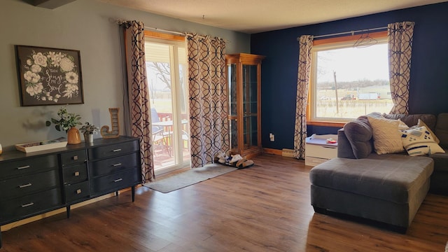living area with wood finished floors and baseboards