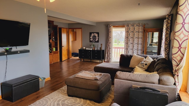 living area with ceiling fan and wood finished floors