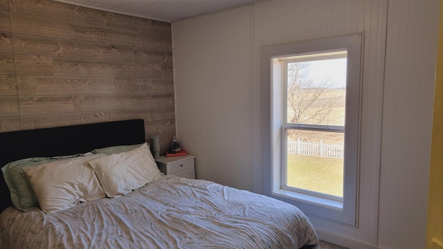 bedroom featuring wood walls