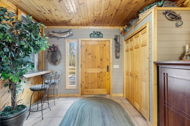 45570 Star Lake Rd, Marcell, MN 56657 - foyer featuring light tile patterned floors, wooden walls, and wood ceiling