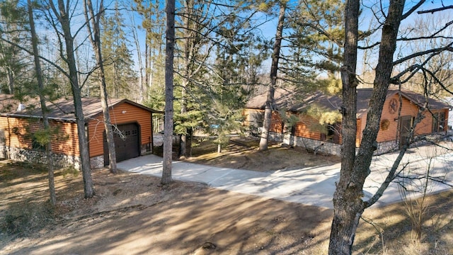 45570 Star Lake Rd, Marcell, MN 56657 - view of front facade featuring driveway, faux log siding, an outdoor structure, and a garage